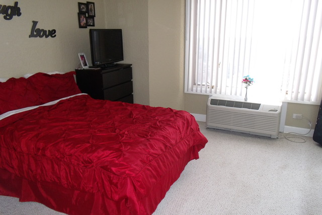 1 Renaissance Place, Unit 1106 Palatine, IL 60067 - Photo 7 of 15 a bedroom with a bed and a flat tv screen on a dresser