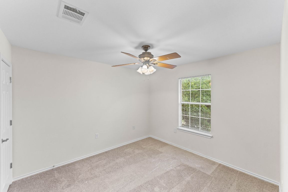 292 Housefinch Loop Leander, TX 78641 - Photo 21 of 29 Spare room featuring light colored carpet and ceiling fan
