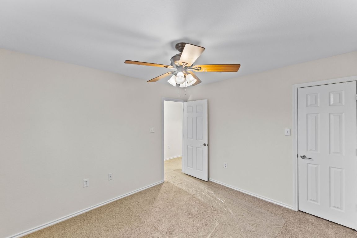 292 Housefinch Loop Leander, TX 78641 - Photo 22 of 29 Unfurnished bedroom featuring light colored carpet and a ceiling fan