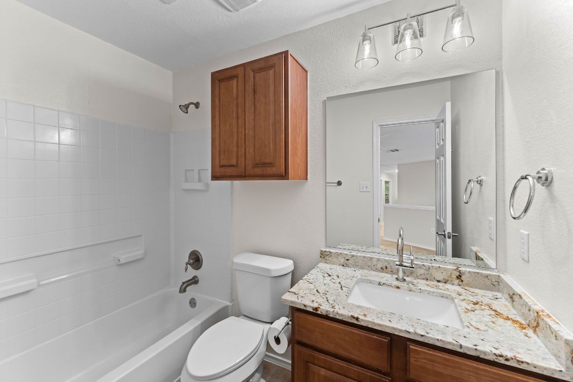 292 Housefinch Loop Leander, TX 78641 - Photo 23 of 29 Full bath with vanity and washtub / shower combination