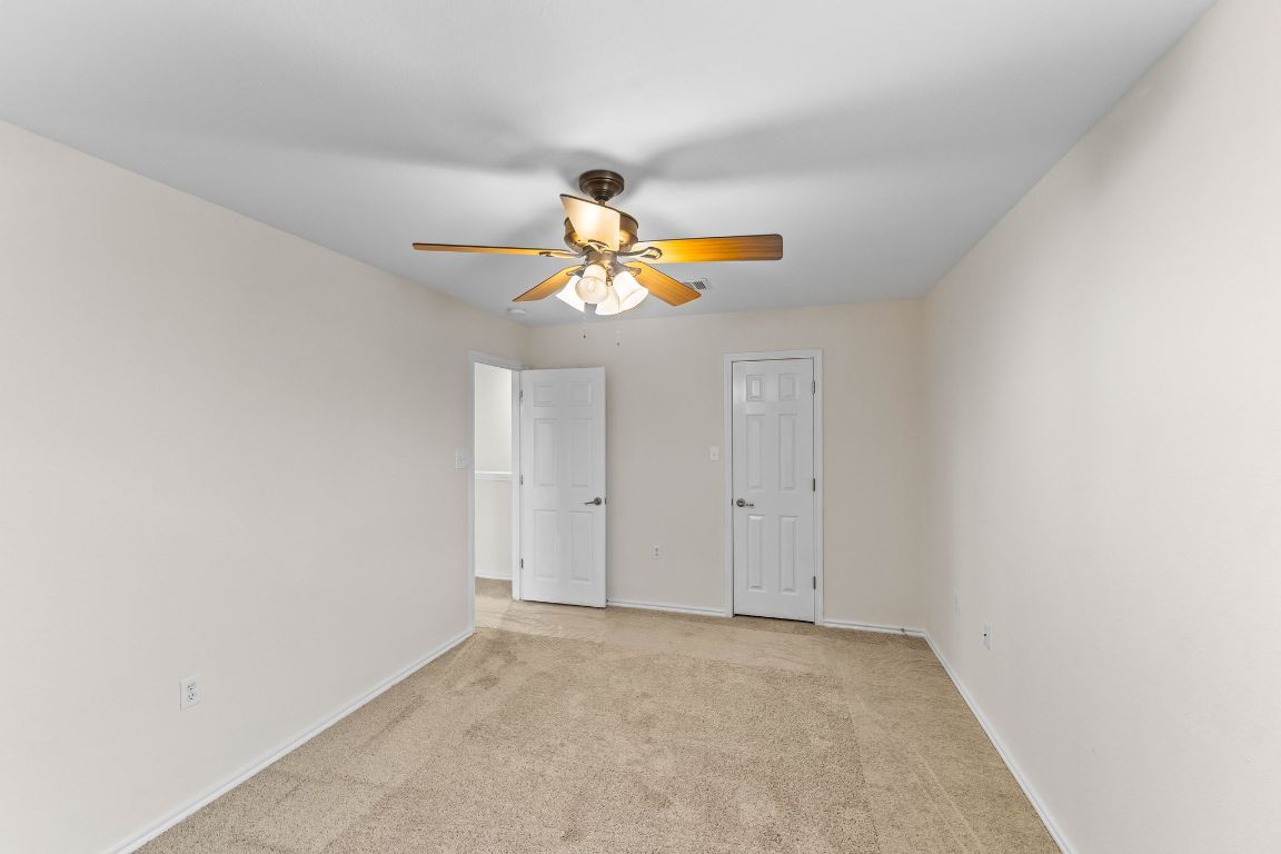292 Housefinch Loop Leander, TX 78641 - Photo 25 of 29 Unfurnished bedroom featuring light colored carpet and ceiling fan