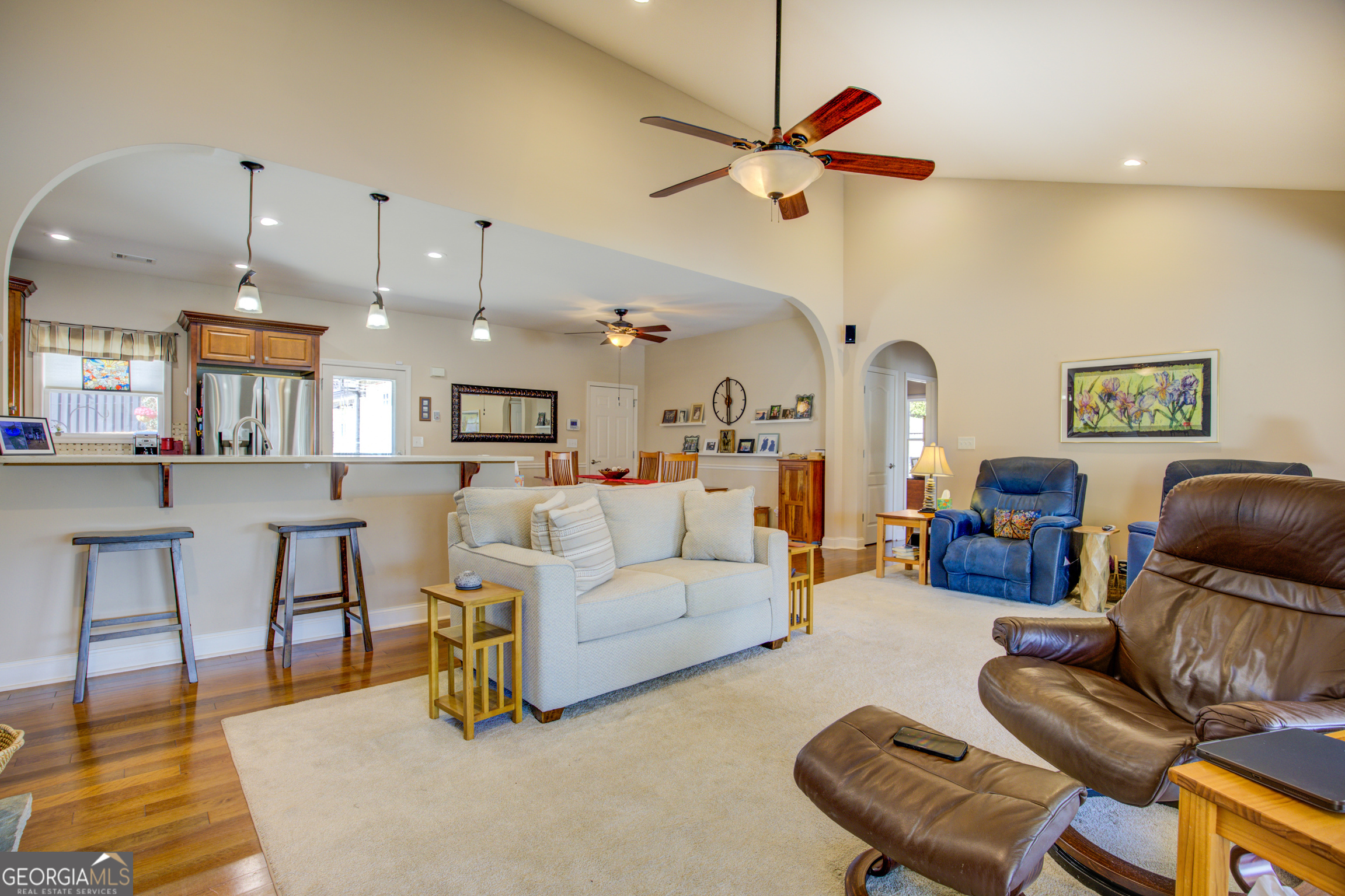 921 Yancey Road Covington, GA 30014 - Photo 24 of 85 a living room with furniture kitchen view and a chandelier