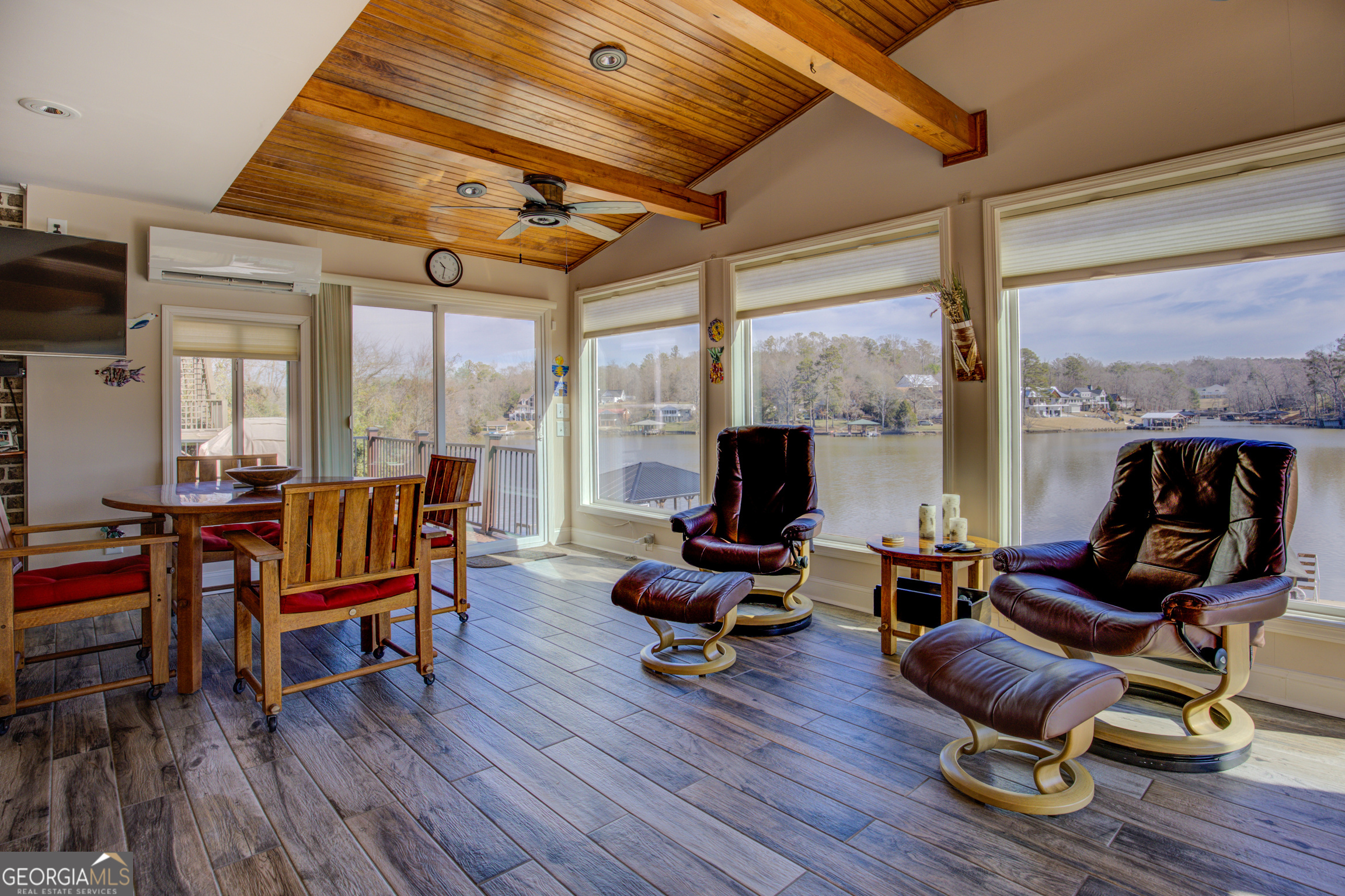 921 Yancey Road Covington, GA 30014 - Photo 26 of 85 a living room with furniture a rug wooden floor and a floor to ceiling window