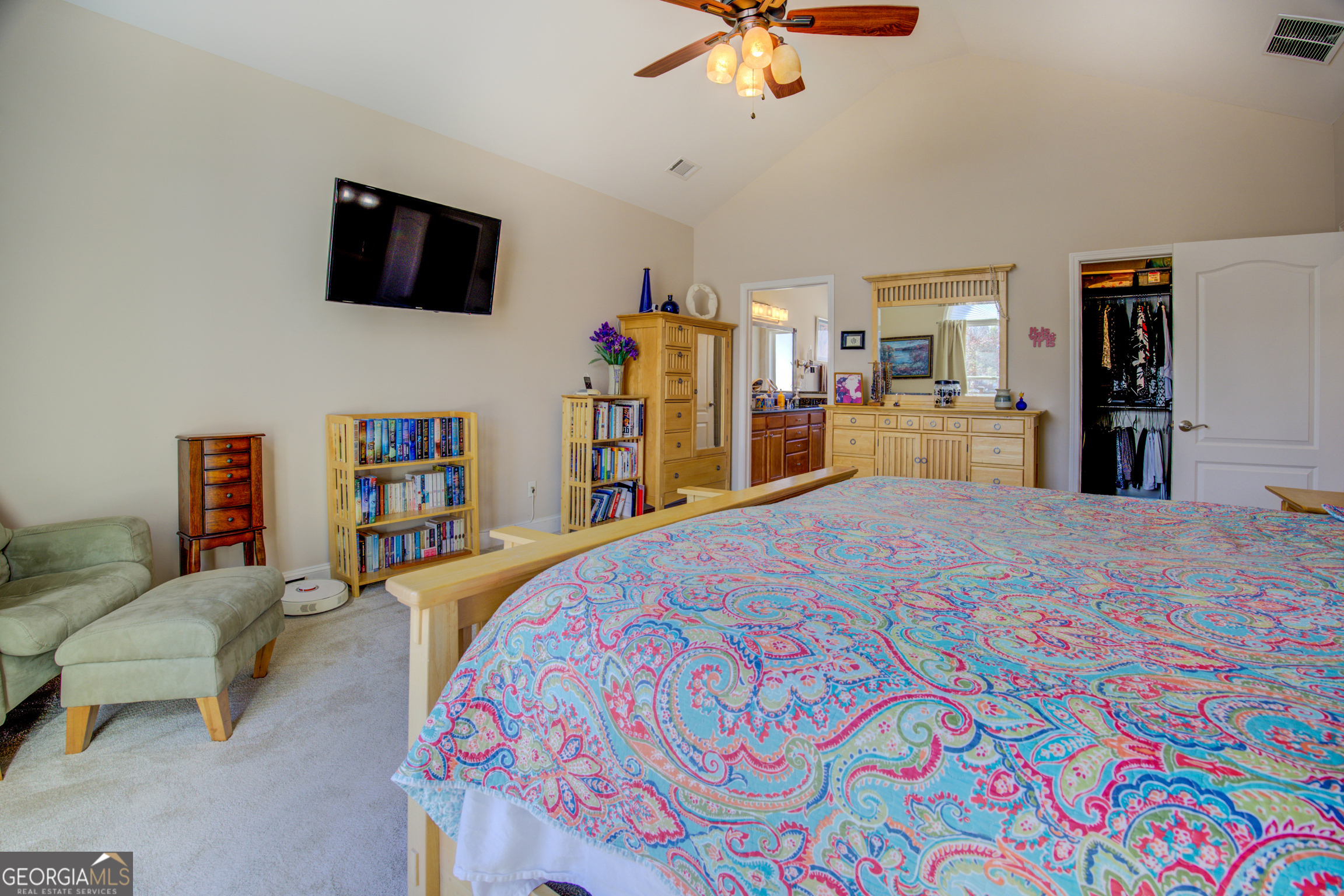 921 Yancey Road Covington, GA 30014 - Photo 33 of 85 a bedroom with a bed a flat screen tv and a chandelier