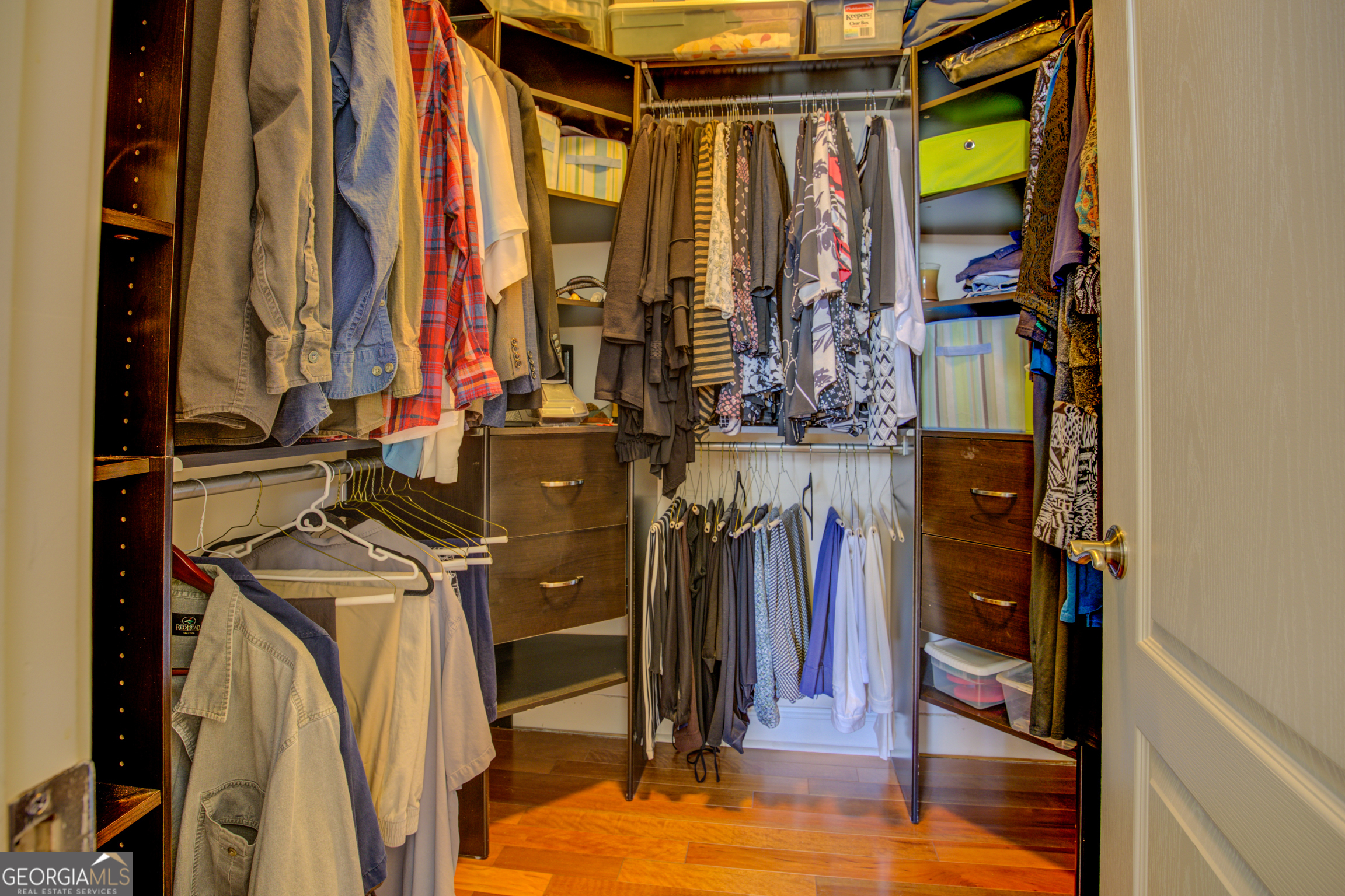921 Yancey Road Covington, GA 30014 - Photo 40 of 85 a view of walk in closet with clothes and shoes