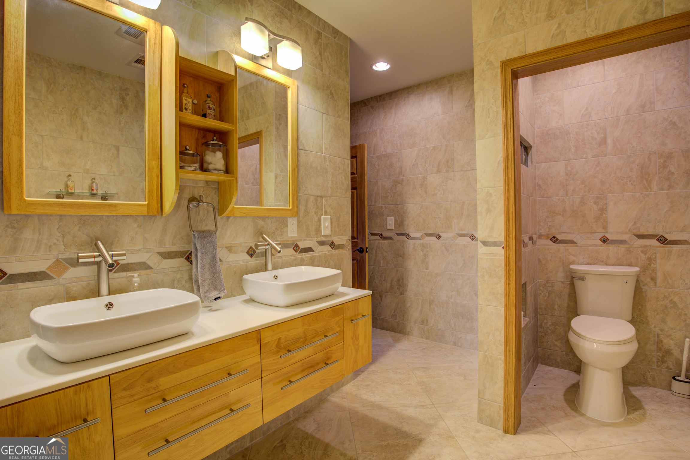 921 Yancey Road Covington, GA 30014 - Photo 64 of 85 a bathroom with a double vanity sink mirror and toilet