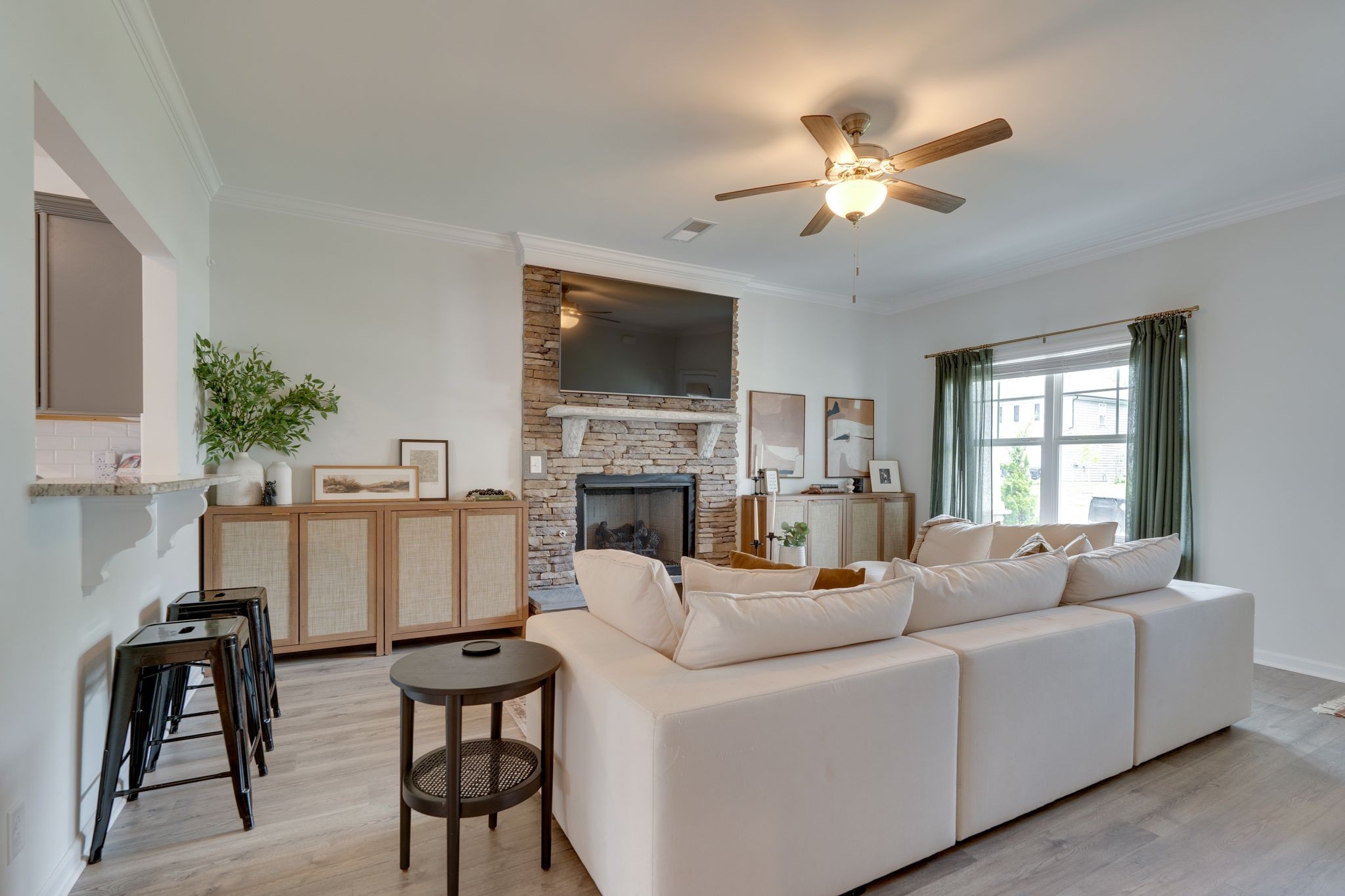 a living room with furniture a flat screen tv and a fireplace
