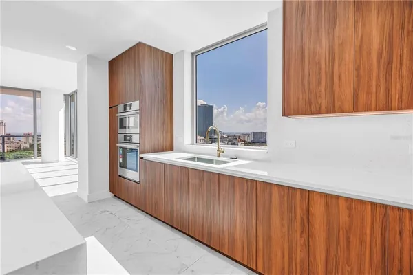 a view of a living room hardwood floor and furniture