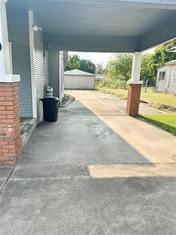 a view of empty room with wooden floor and fireplace