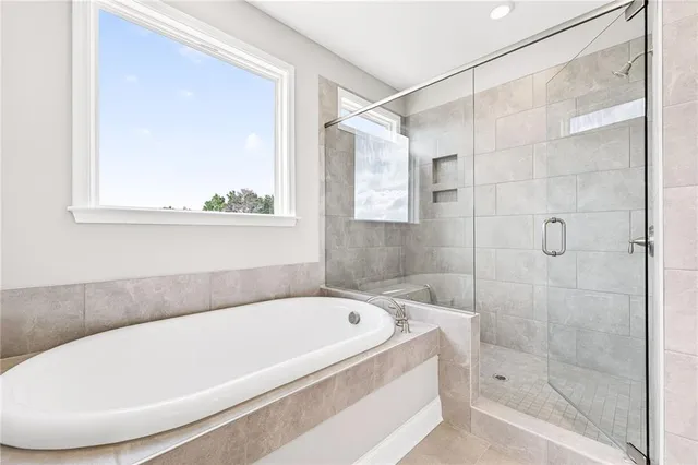 a white bath tub sitting next to a shower