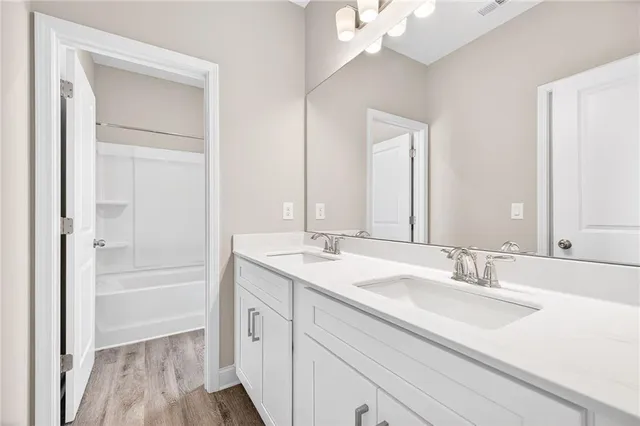 a bathroom with a sink a vanity and a mirror