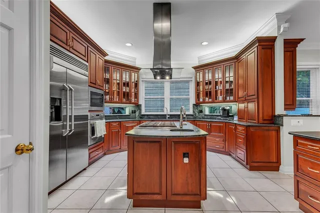 a kitchen with stainless steel appliances granite countertop a sink and a refrigerator