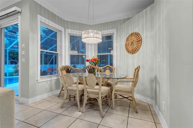 a dining room with furniture a chandelier and wooden floor
