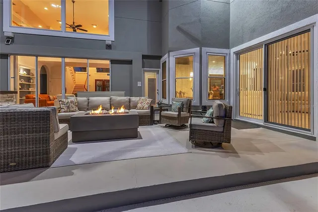 a living room with furniture and large windows