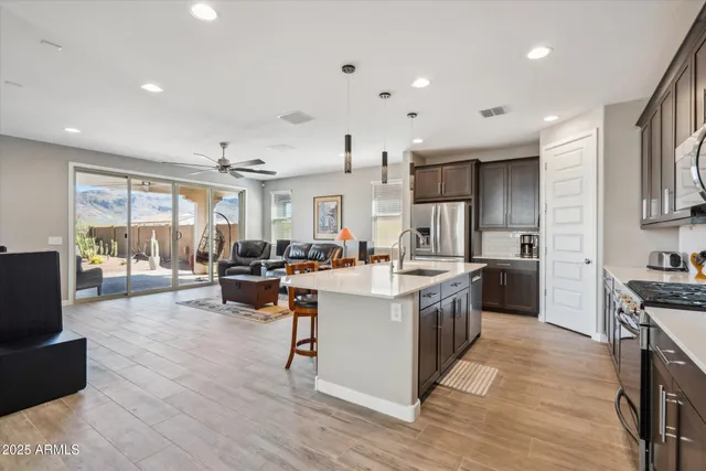 a kitchen with counter top space a sink appliances and cabinets