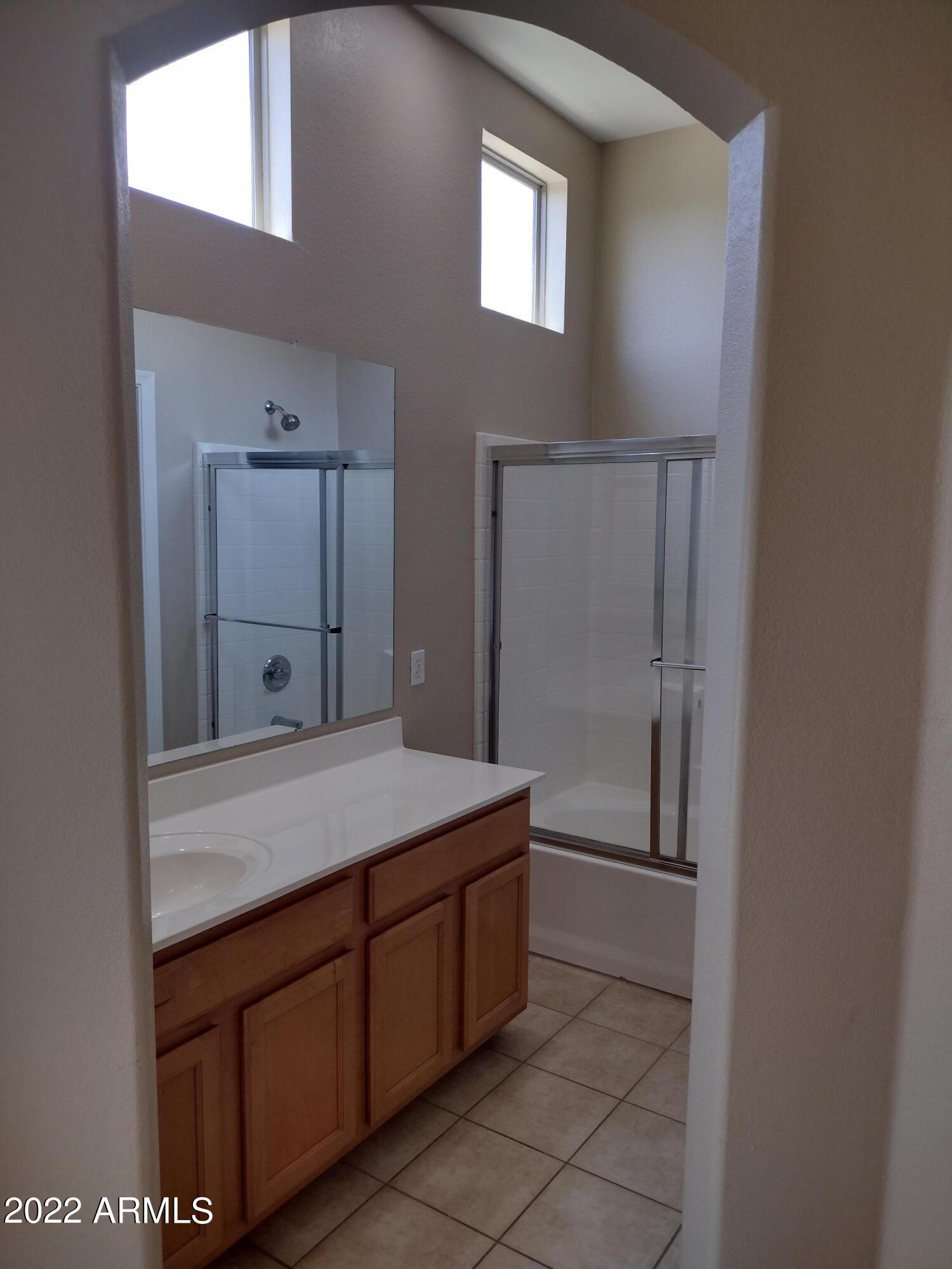 2401 East Rio Salado Parkway, Unit 1076 Tempe, AZ 85288 - Photo 13 of 15 a bathroom with a granite countertop sink a toilet and mirror