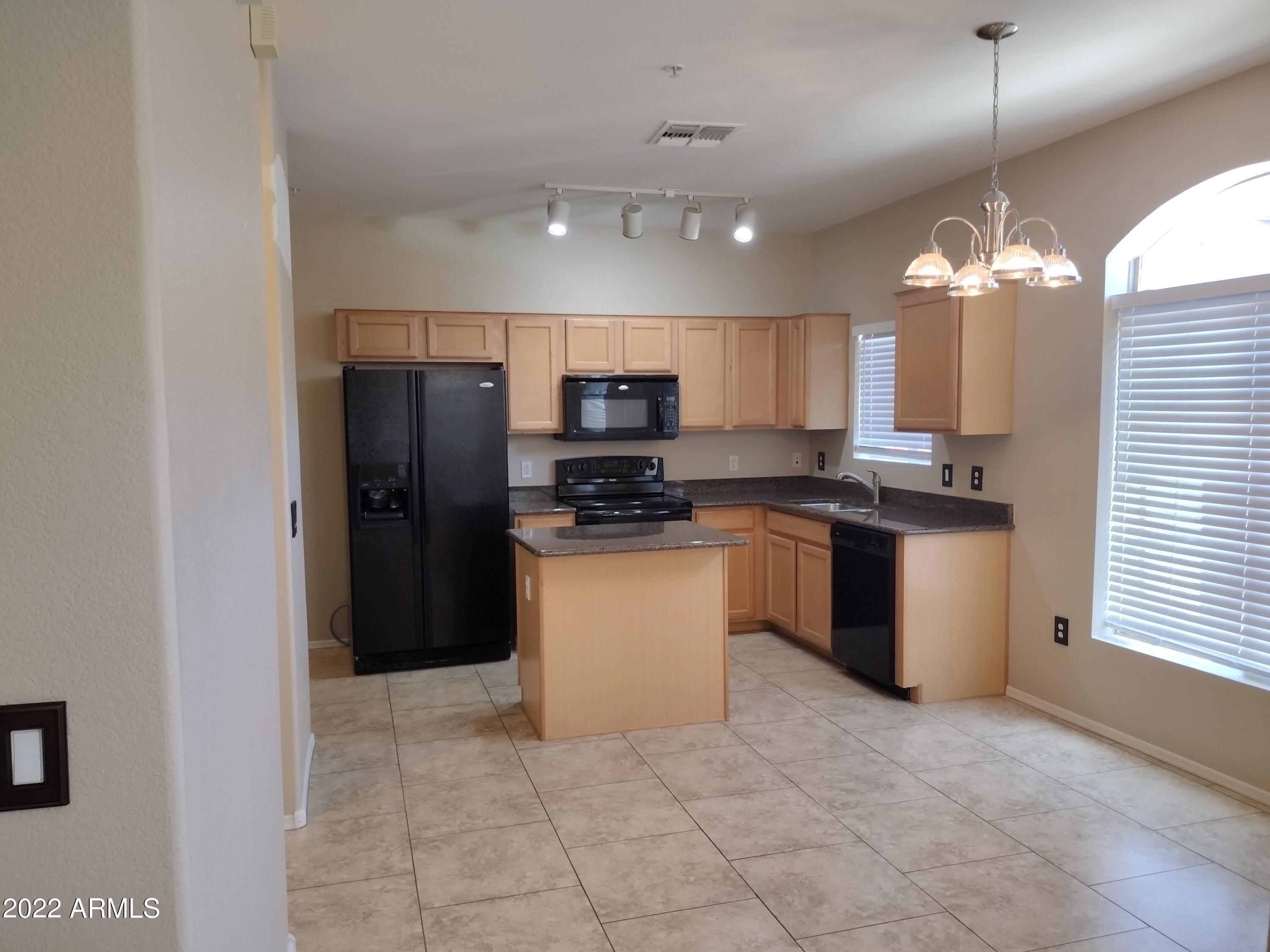 2401 East Rio Salado Parkway, Unit 1076 Tempe, AZ 85288 - Photo 4 of 15 a kitchen with a refrigerator a microwave a sink and a stove
