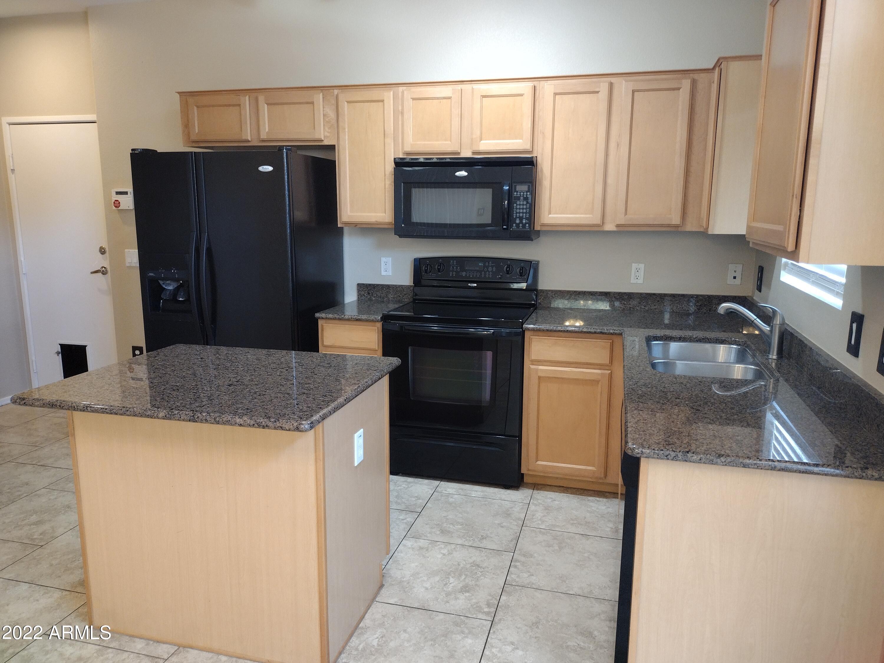 2401 East Rio Salado Parkway, Unit 1076 Tempe, AZ 85288 - Photo 5 of 15 a kitchen with stainless steel appliances granite countertop a stove a refrigerator a sink a microwave and a refrigerator
