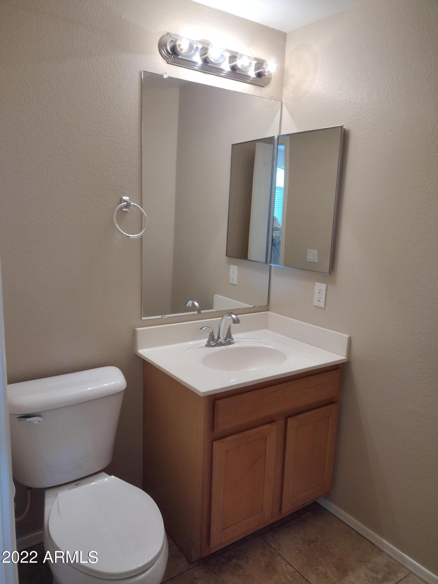 2401 East Rio Salado Parkway, Unit 1076 Tempe, AZ 85288 - Photo 6 of 15 a bathroom with a toilet sink and mirror