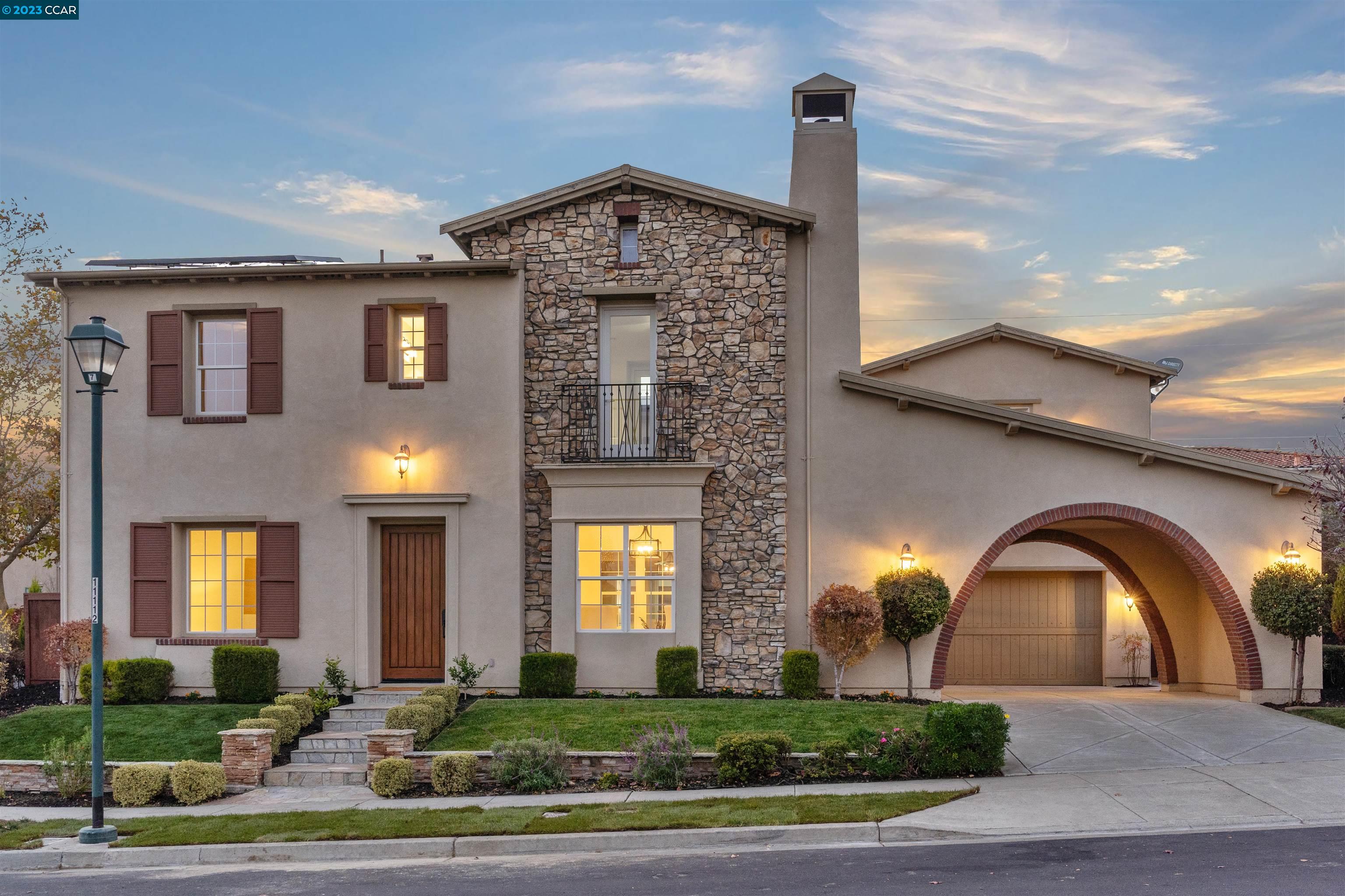 a front view of a house with garden