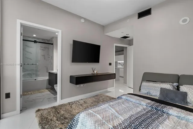 a bedroom with a bed and a television in it