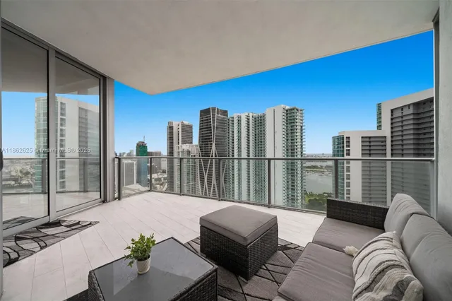 a balcony with furniture and a floor to ceiling window