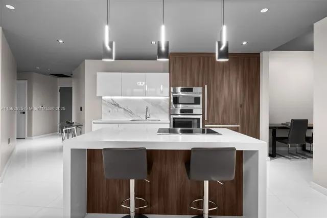 a large kitchen with a table and chairs