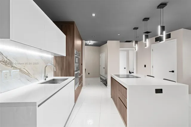 a large white kitchen with a large window