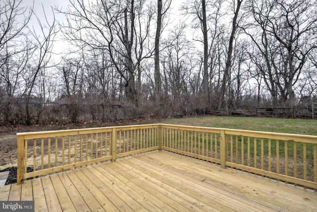 a view of deck with mountain view and wooden floor