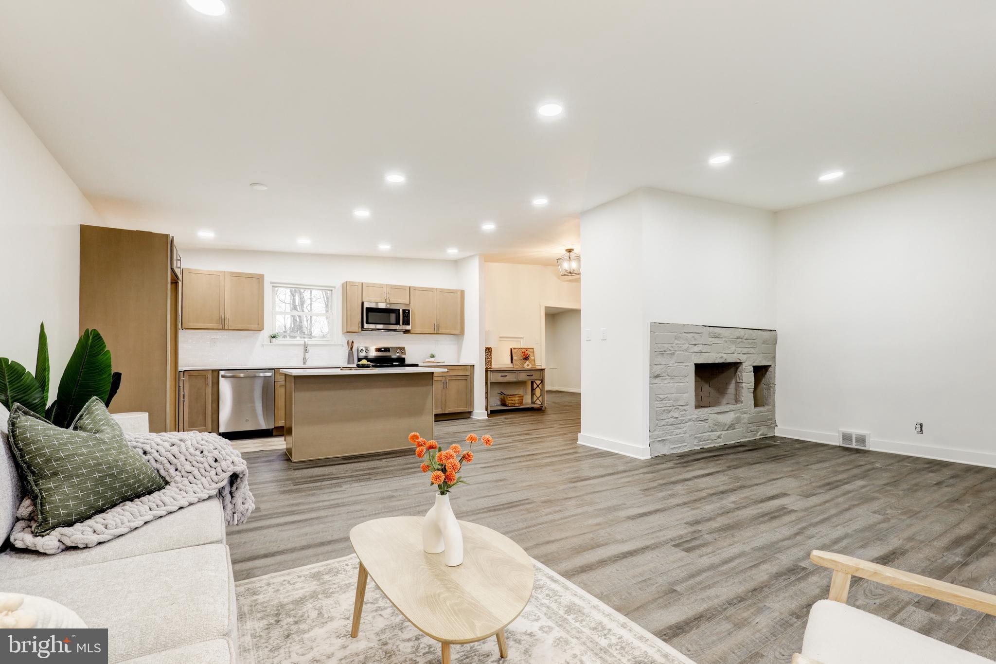 904 South Chester Road West Chester, PA 19382 - Photo 16 of 47 a living room with furniture kitchen view and a fireplace
