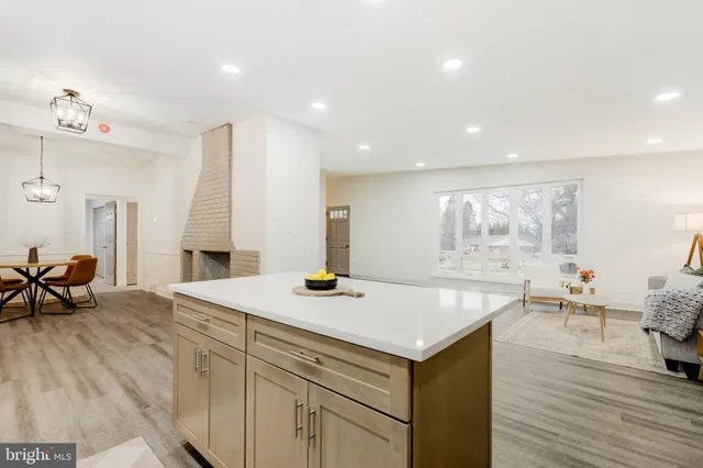 a view of kitchen island wooden floor and living room
