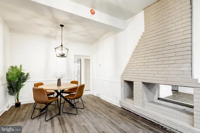 a view of a dining room with furniture wooden floor and chandelier