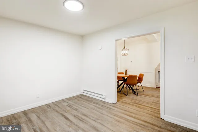 a view of a room with wooden floor and bench