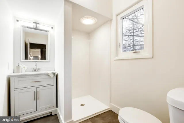 a bathroom with a bathtub sink vanity and mirror