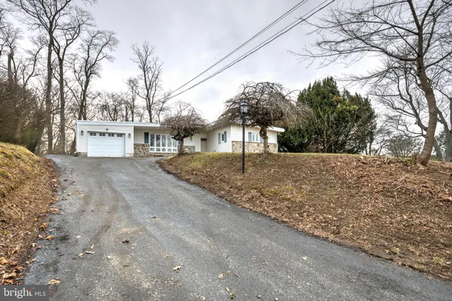 a view of white house with a snow on the road