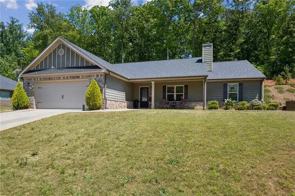 a front view of a house with a garden