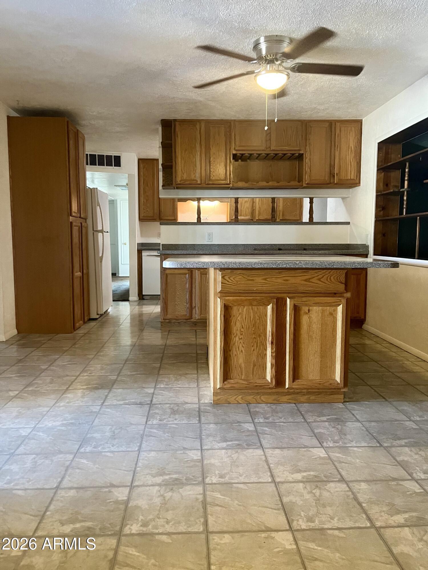 2315 West Butler Drive Phoenix, AZ 85021 - Photo 3 of 13 a kitchen with a refrigerator and a counter top space