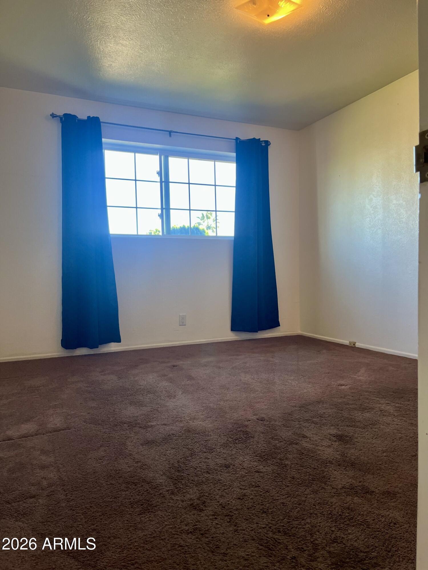 2315 West Butler Drive Phoenix, AZ 85021 - Photo 5 of 13 a view of an empty room with a window