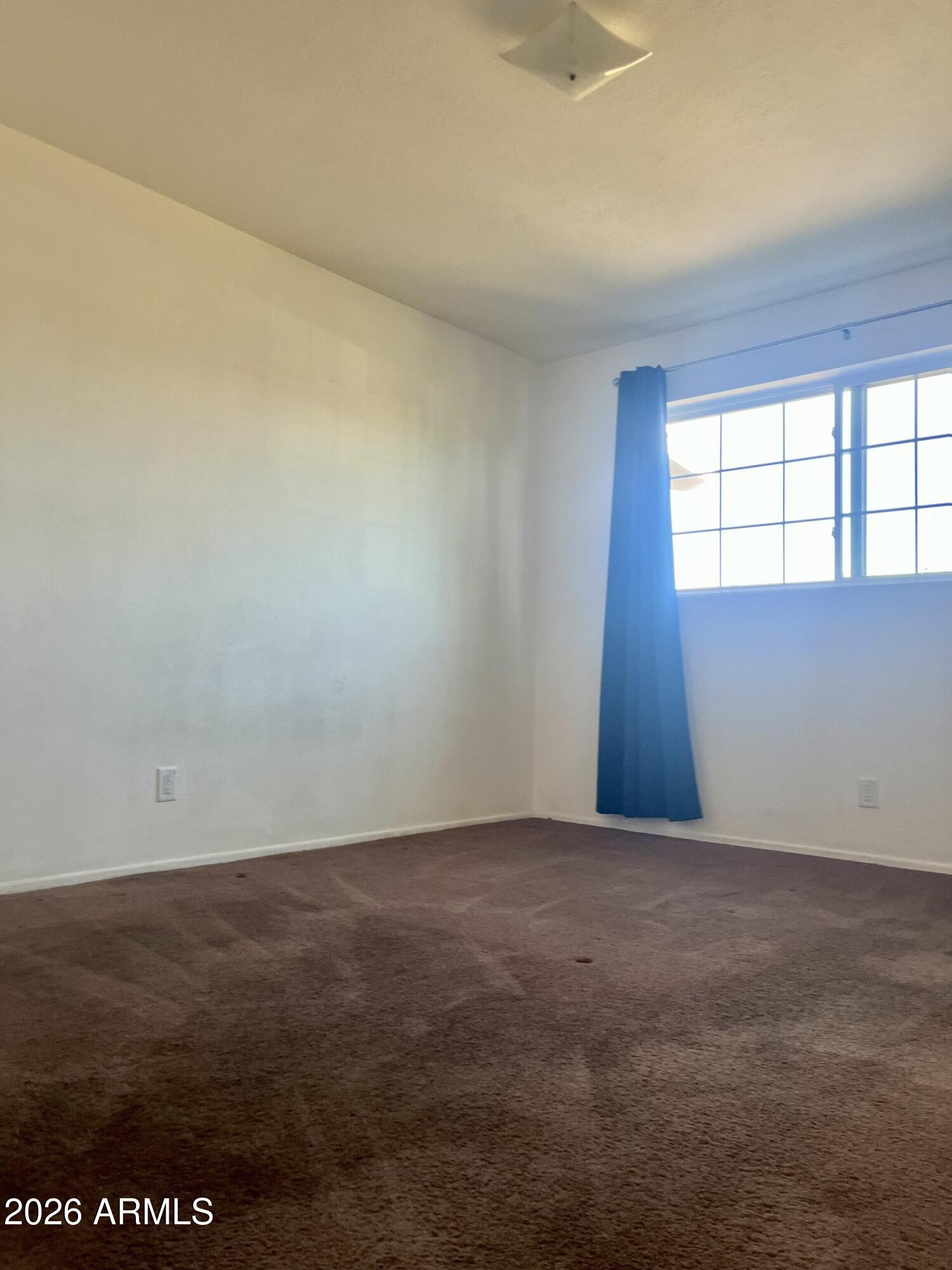 2315 West Butler Drive Phoenix, AZ 85021 - Photo 7 of 13 an empty room with a window