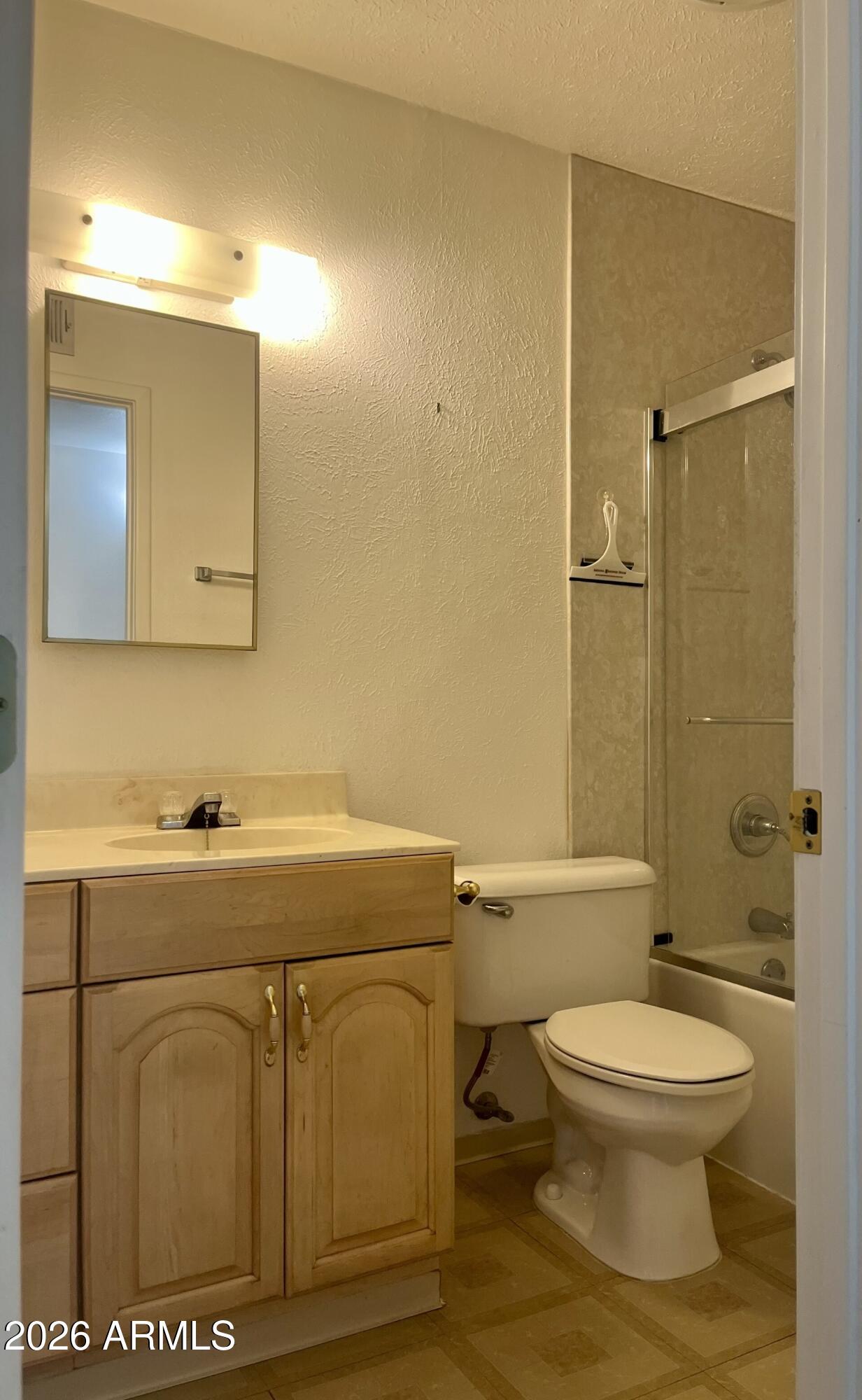 2315 West Butler Drive Phoenix, AZ 85021 - Photo 8 of 13 a bathroom with a toilet a sink and mirror