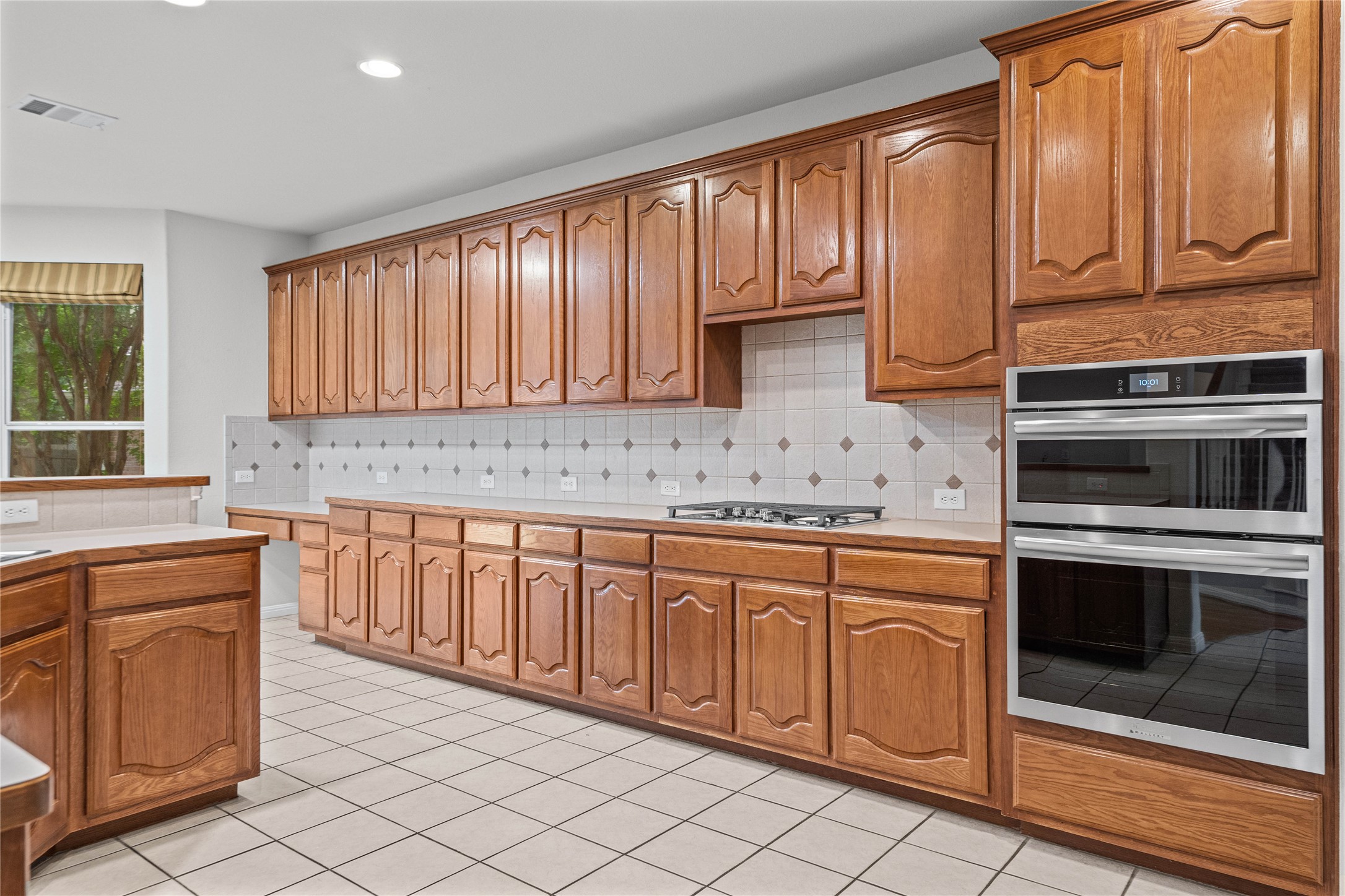 10700 Pointe View Drive Austin, TX 78738 - Photo 10 of 35 A classic kitchen with abundant wood cabinetry and a sleek gas range for culinary pursuits.