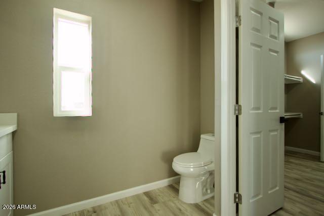 1470 South Bowman Road Apache Junction, AZ 85119 - Photo 36 of 56 a white toilet sitting next to a bathroom sink and vanity