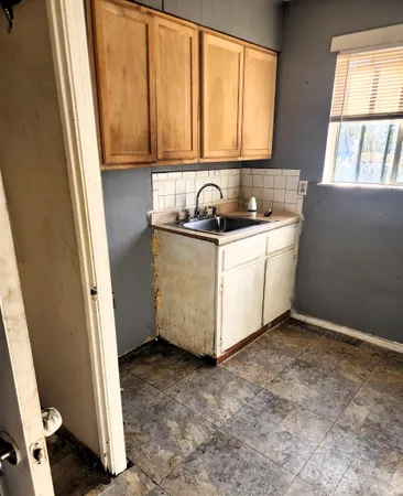a view of a sink and dishwasher with wooden floor