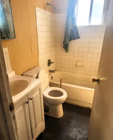 a bathroom with a sink toilet and shower