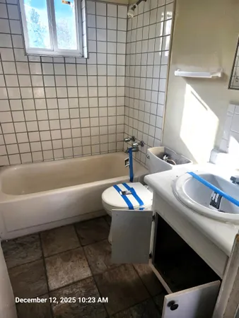 a bathroom with a sink a toilet and mirror