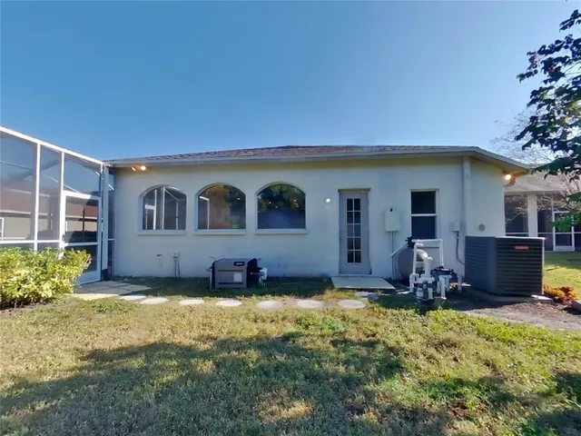a house view with swimming pool in front of it