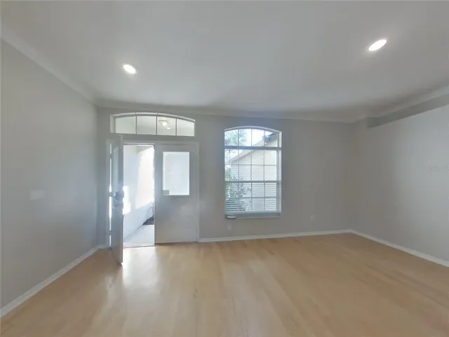 an empty room with windows and closet