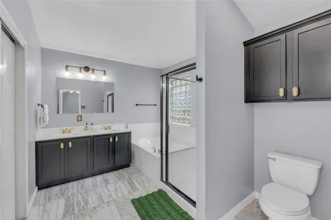 a bathroom with a sink toilet and mirror