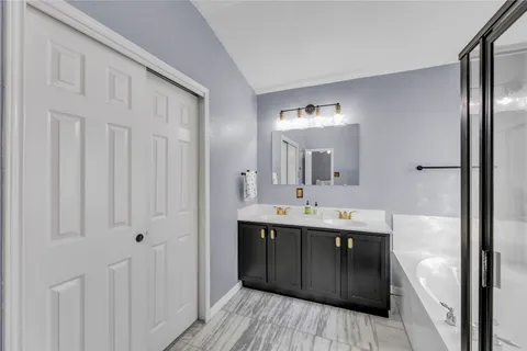 a bathroom with a double vanity sink and mirror