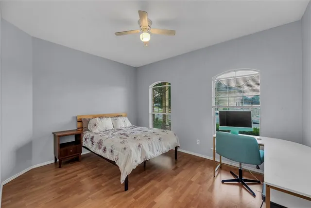 a bedroom with a bed window and a desk